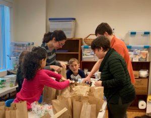 Assembling lunch bags for the Lowell Transitional Living Center